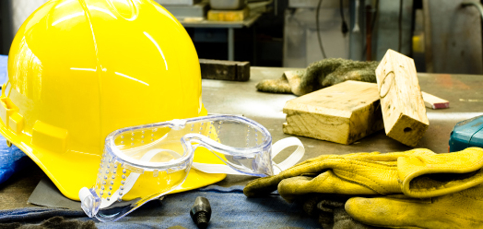 A yellow hardhat, clear safety goggle and worker gloves